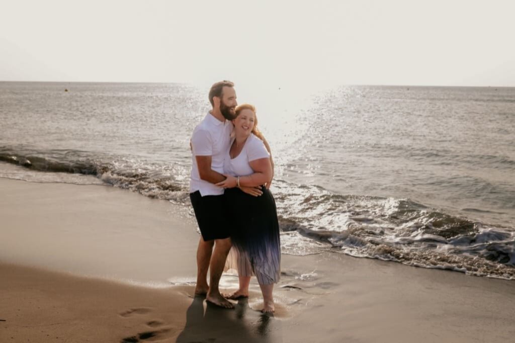 Photo prise par @sophiebacherephotos. La photo montre un couple au bord de l'eau sur la plage